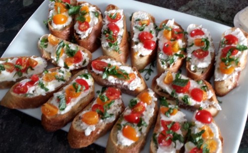  crostini with burrata homegrown tomatoes and drizzle of olive oil